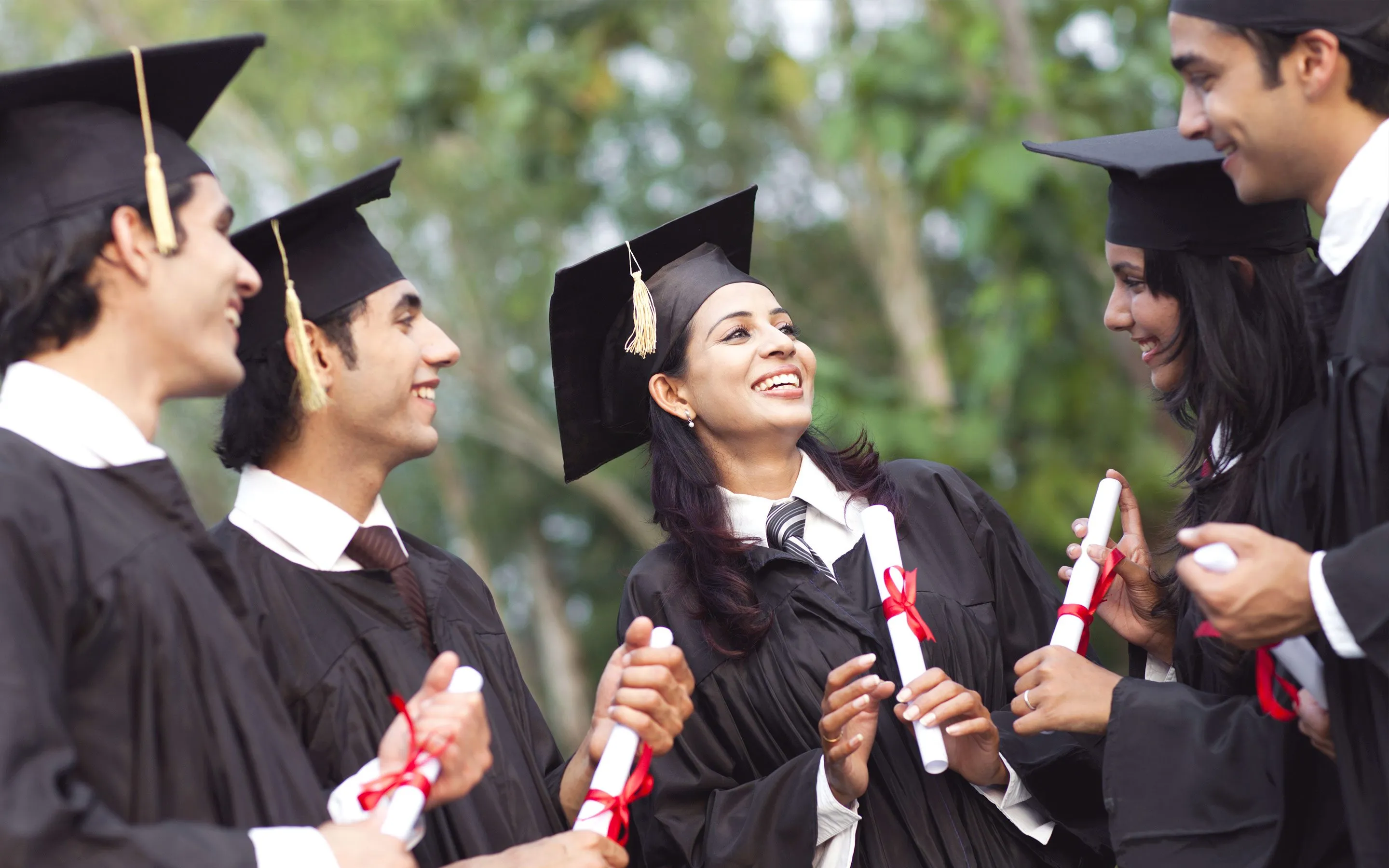 Happy PN EDUCARE students celebrating their graduation in caps and gowns